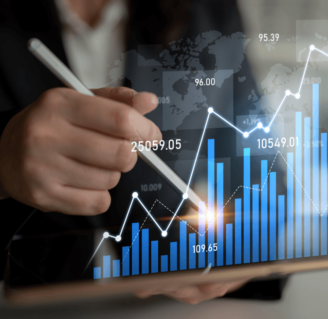 Two colleagues reviewing printed financial charts and reports at a desk