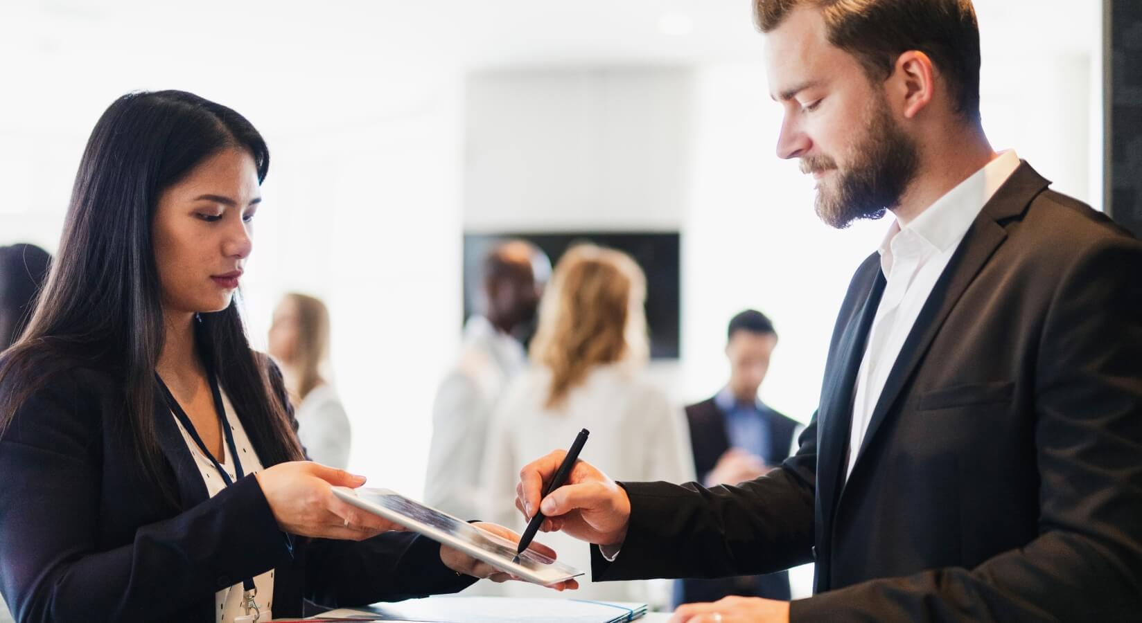 An e-signature being captured on a tablet at a professional event