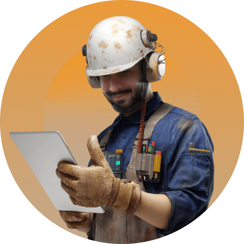Manufacturing worker in a hard hat using a tablet on the shop floor