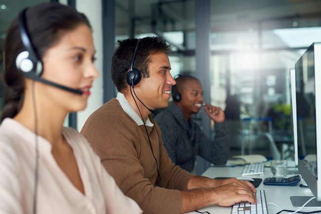 Helpdesk team handling support calls from a shared workspace