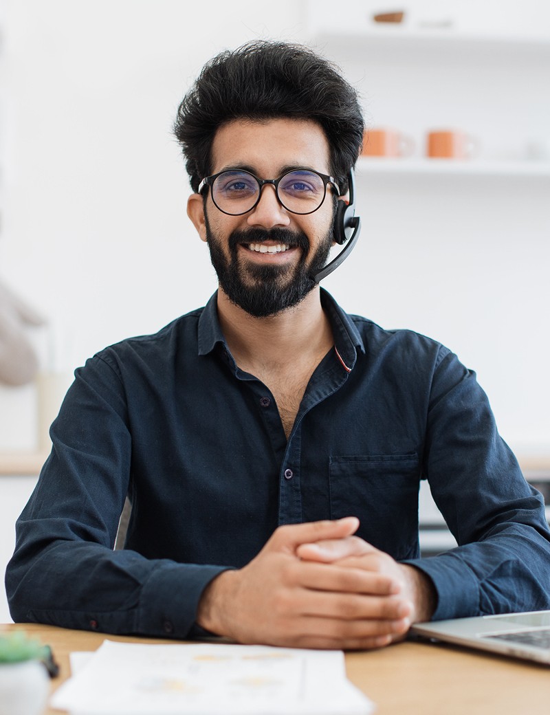 Smiling support agent ready to help on a remote session