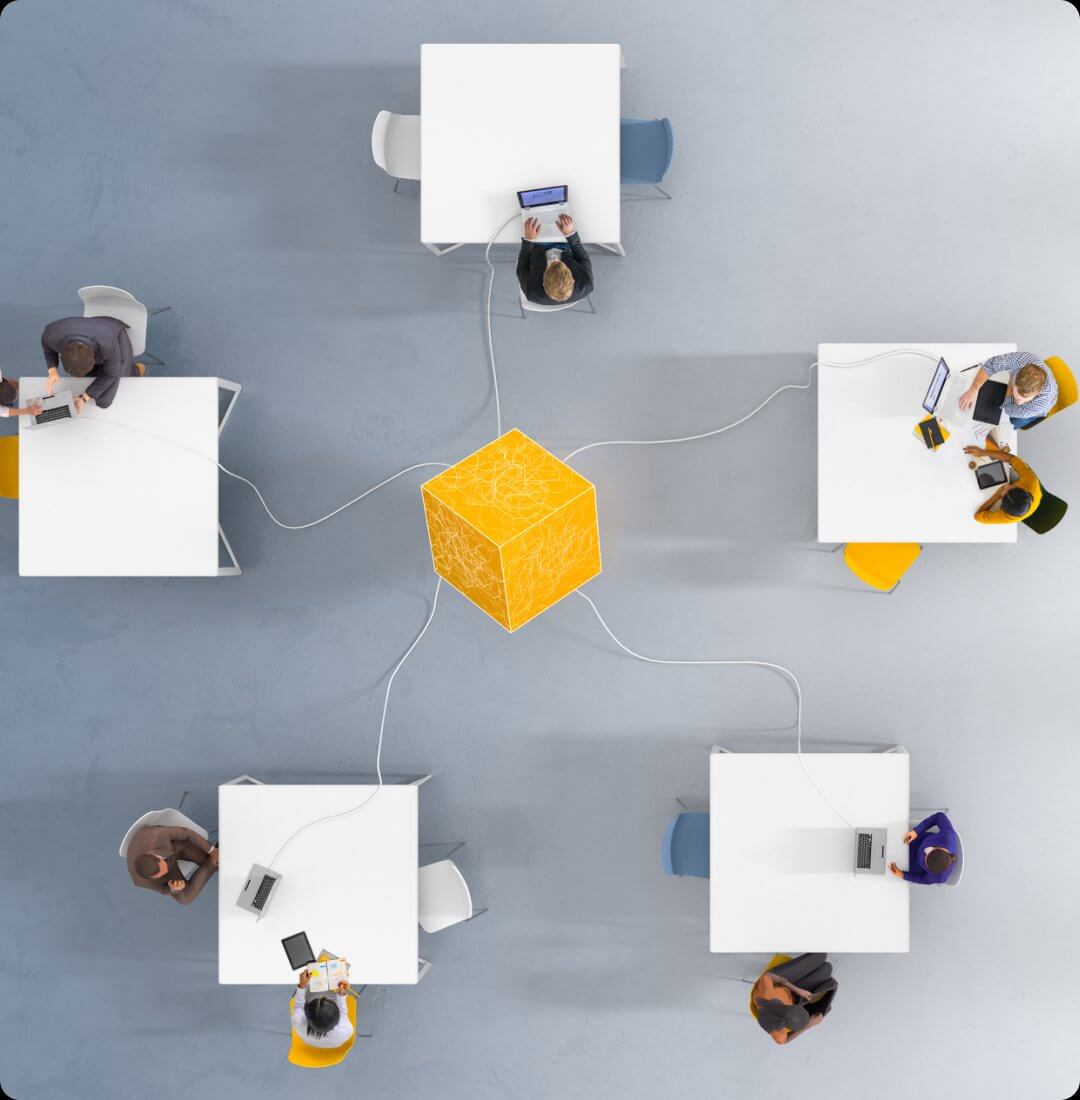 Teams collaborating at connected workstations from aerial view