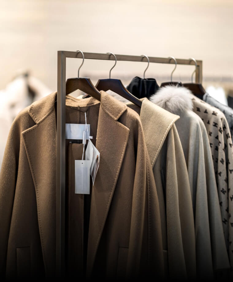 Coats and jackets displayed on hangers in a franchise store