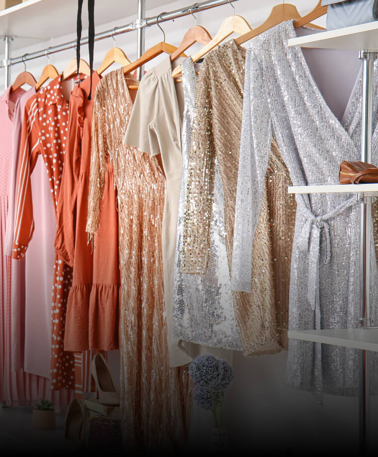 Colorful dresses hanging on a clothing rack in a boutique