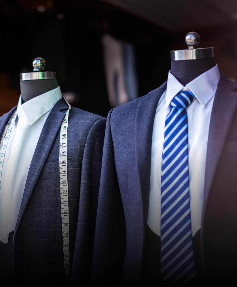 Formal suits displayed on mannequins in a specialty store